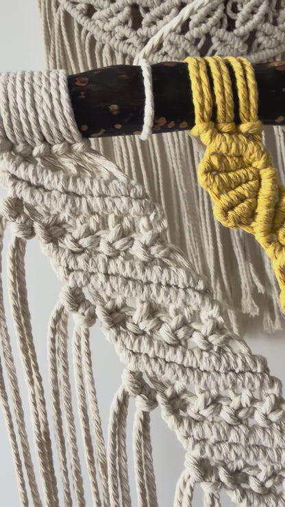 Close-up side view of the handmade macrame wall hanging showcasing intricate knotwork and layered cotton textures.