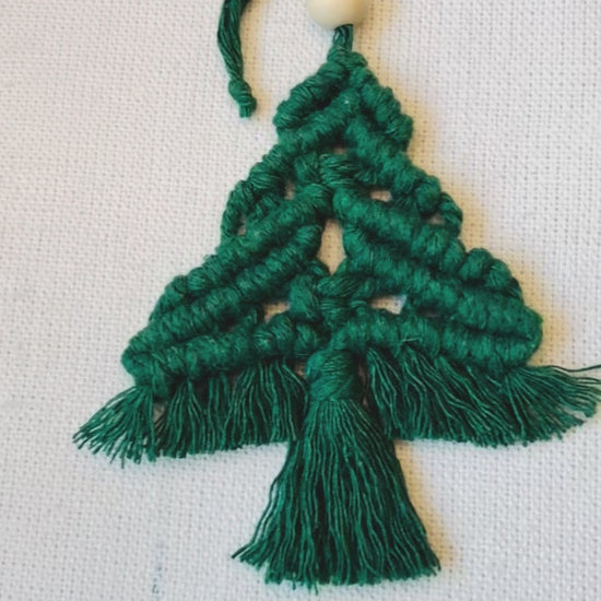 Handmade green macrame Christmas tree ornament showing the knotted details