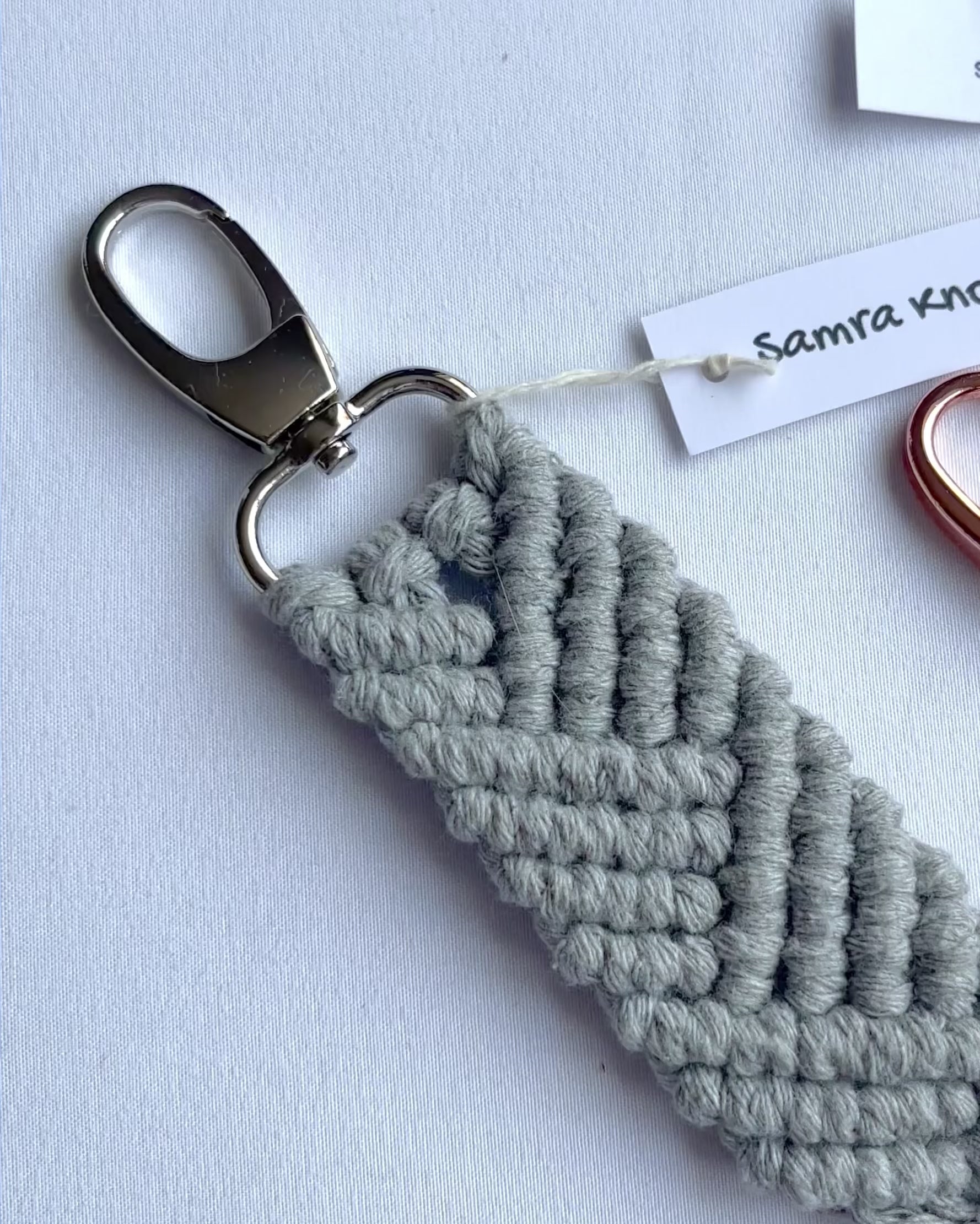 Showcase of handmade macrame mermaid keyrings in multiple colours with tassels, cotton bag charms and thoughtful handmade gifts.