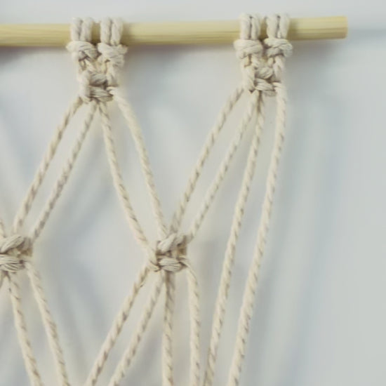Video showing the handmade macrame photo holder and knotted cotton details