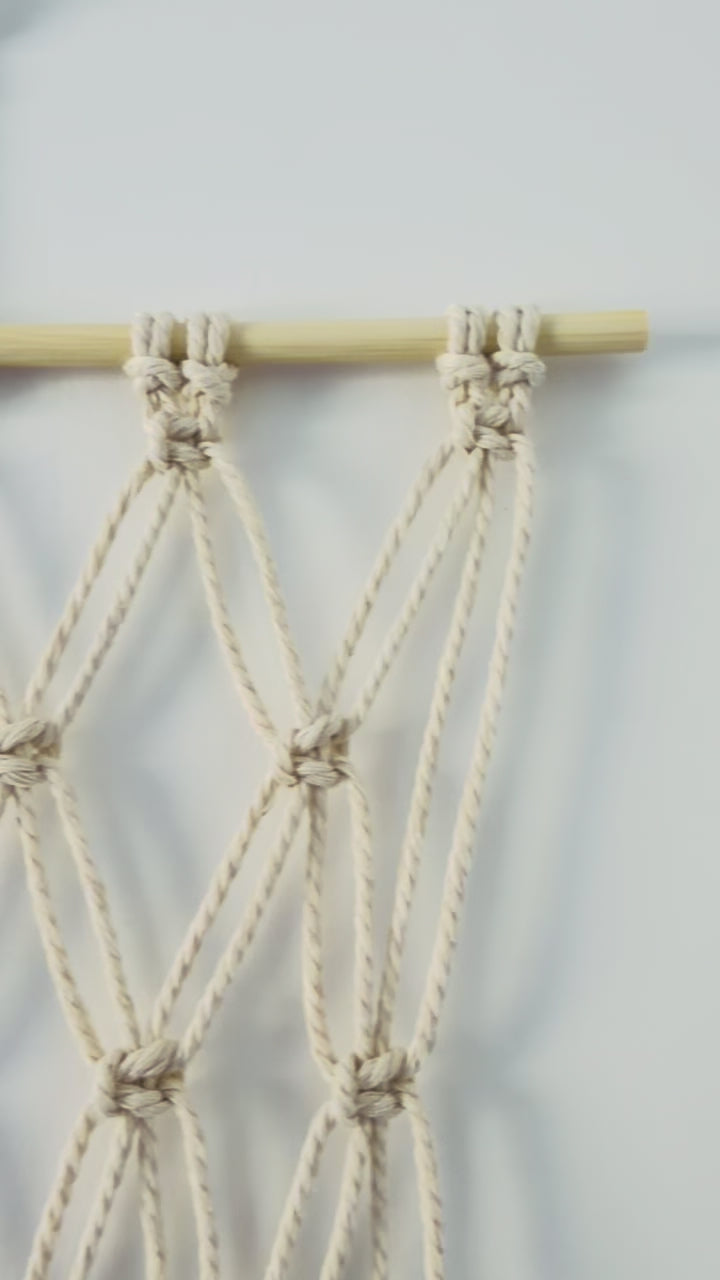 Video showing the handmade macrame photo holder and knotted cotton details
