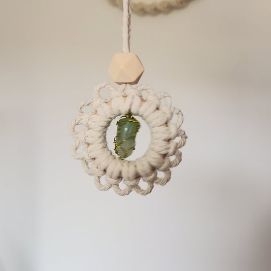 Video showing a handmade macrame gemstone car charm and essential oil diffuser from different angles.