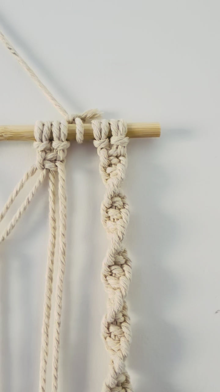 Handmade macrame photo holder with five leaves showing knot and cotton details.