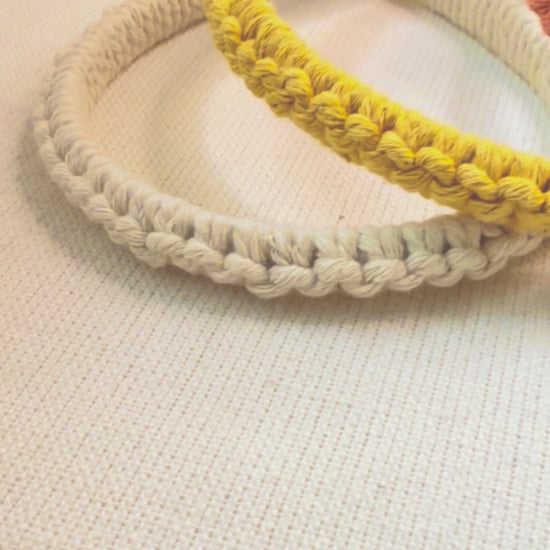Video showing handmade cotton macramé headband from different angles.