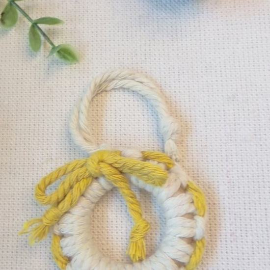 Handmade macrame Christmas wreath ornament showing the cotton cord details