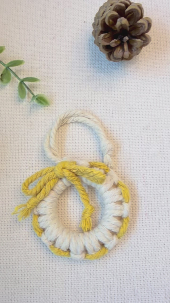 Handmade macrame Christmas wreath ornament showing the cotton cord details