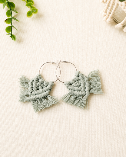Handmade sage green macrame chevron hoop earrings with silver hoops and cotton fringe.