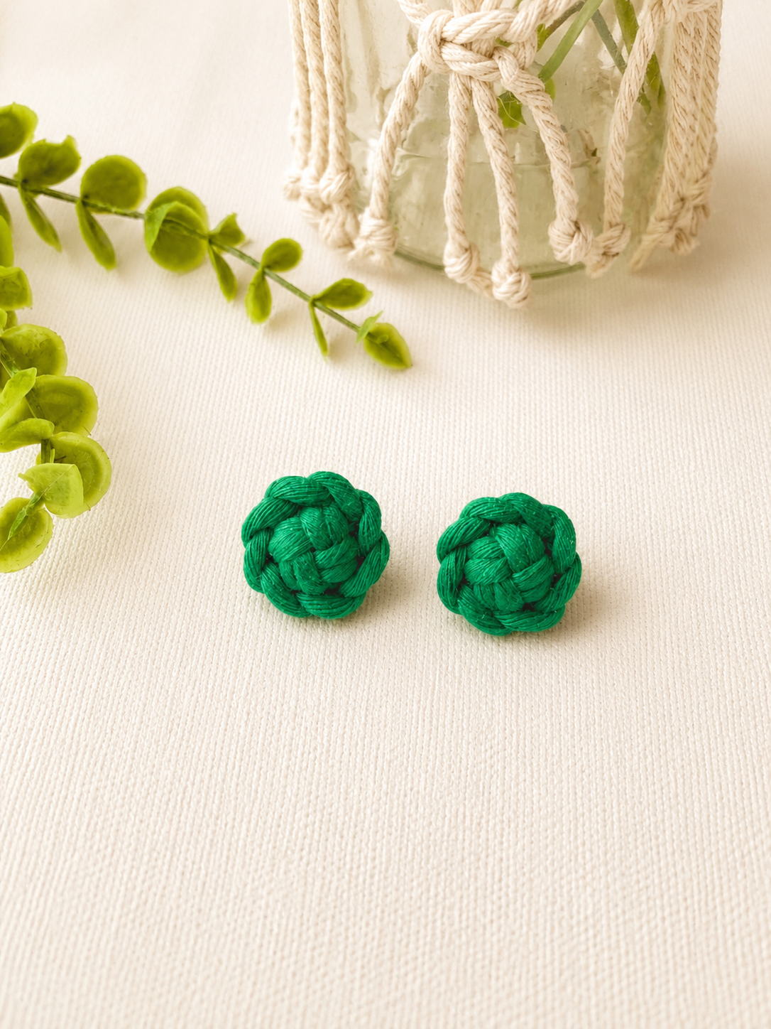 Green handmade macramé flower stud earrings made from cotton cord.