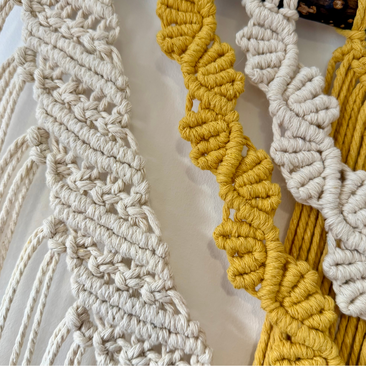 Close-up of carefully hand-knotted Samra Knots macrame showing neat mustard and natural cotton knotwork.
