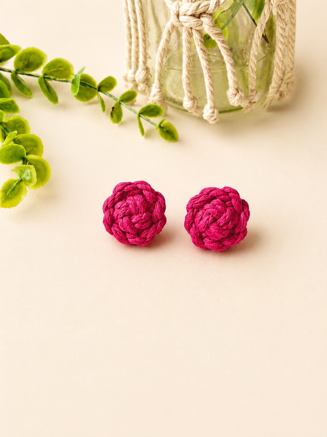 Pink handmade macramé flower stud earrings with a floral-inspired design.