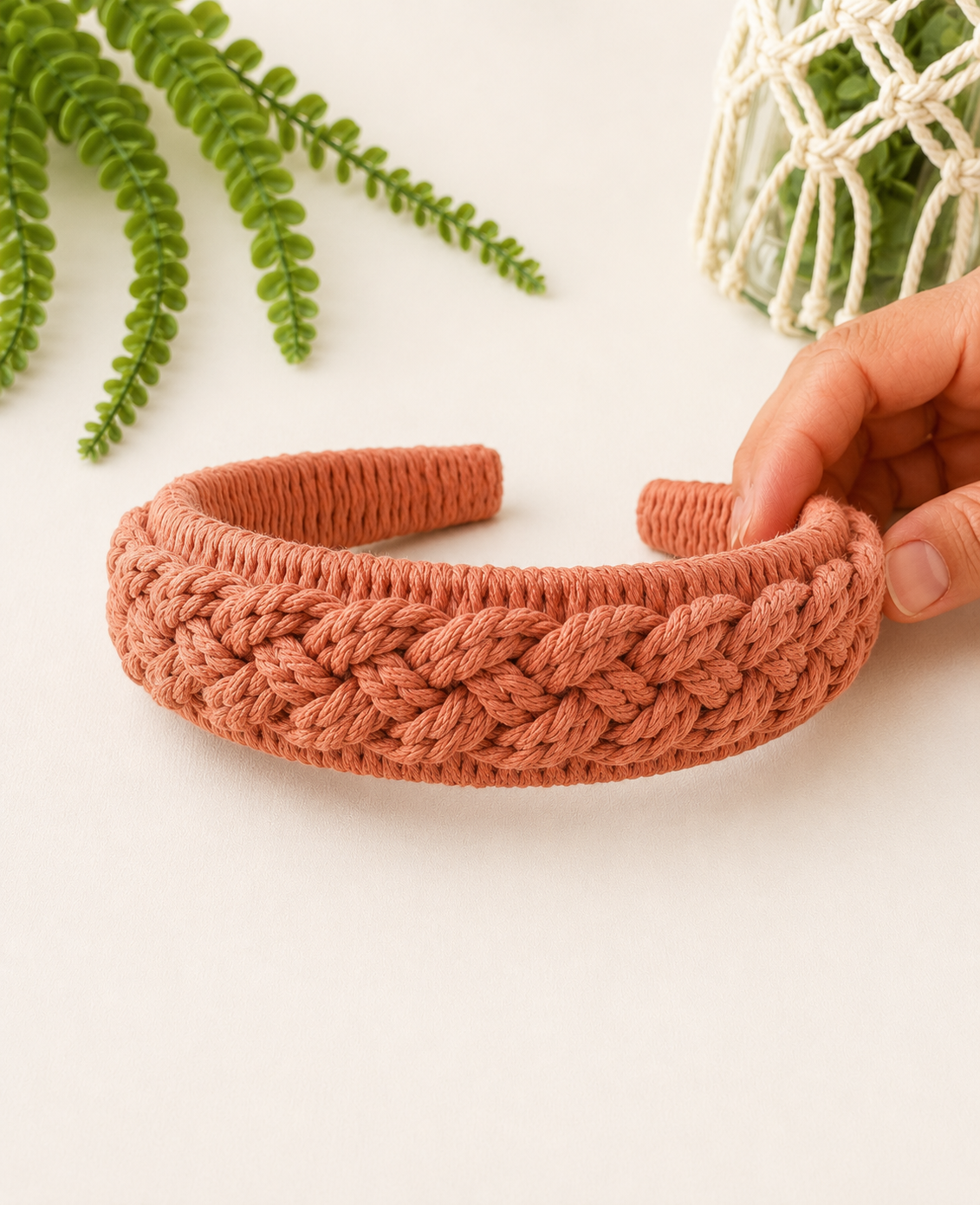 Handmade terracotta macrame headband with textured braided knot pattern