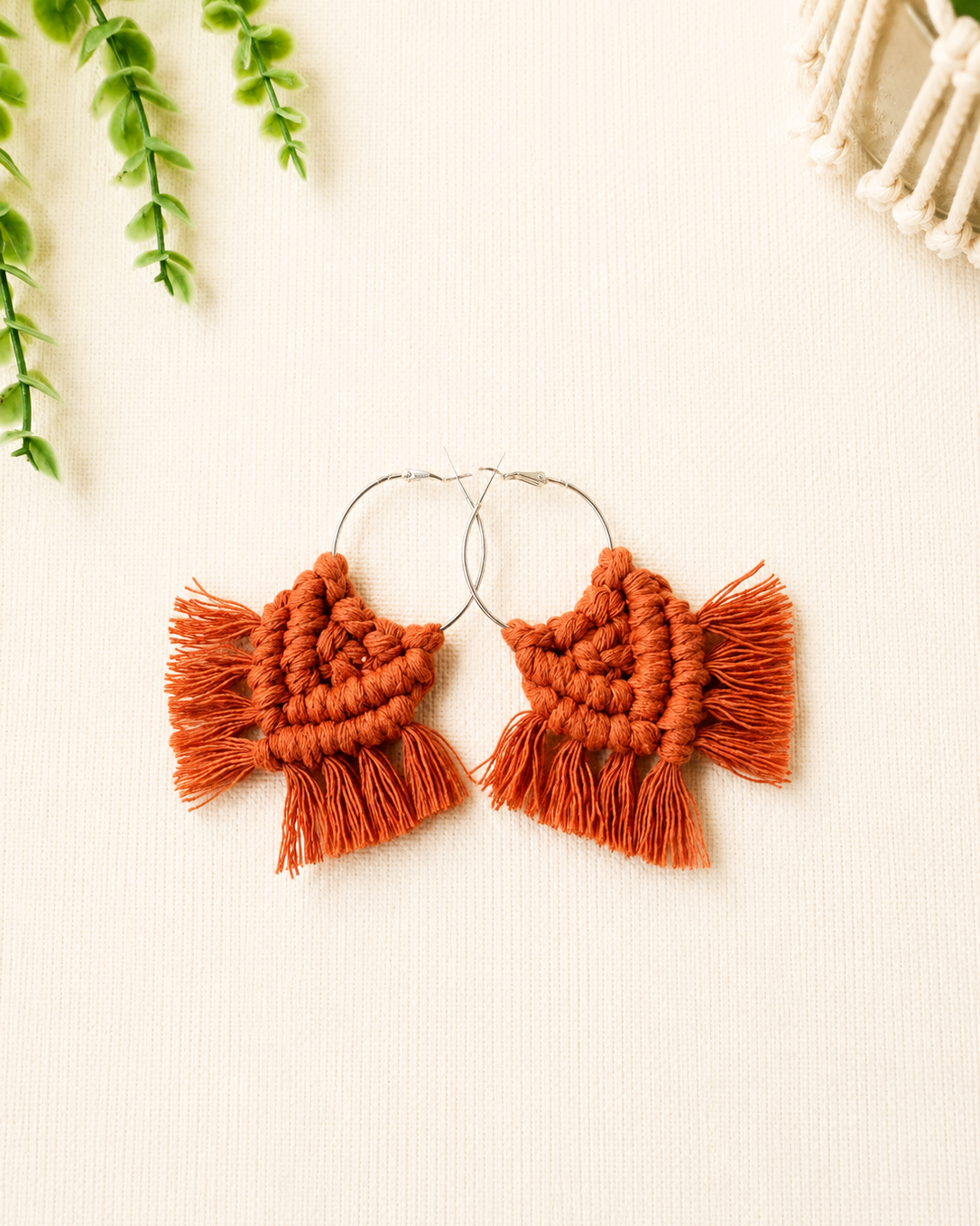 Handmade terracotta macrame chevron hoop earrings with silver hoops and cotton fringe.