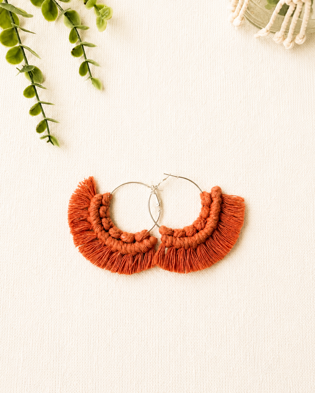 Handmade terracotta macrame fringe hoop earrings with stainless steel hoops.
