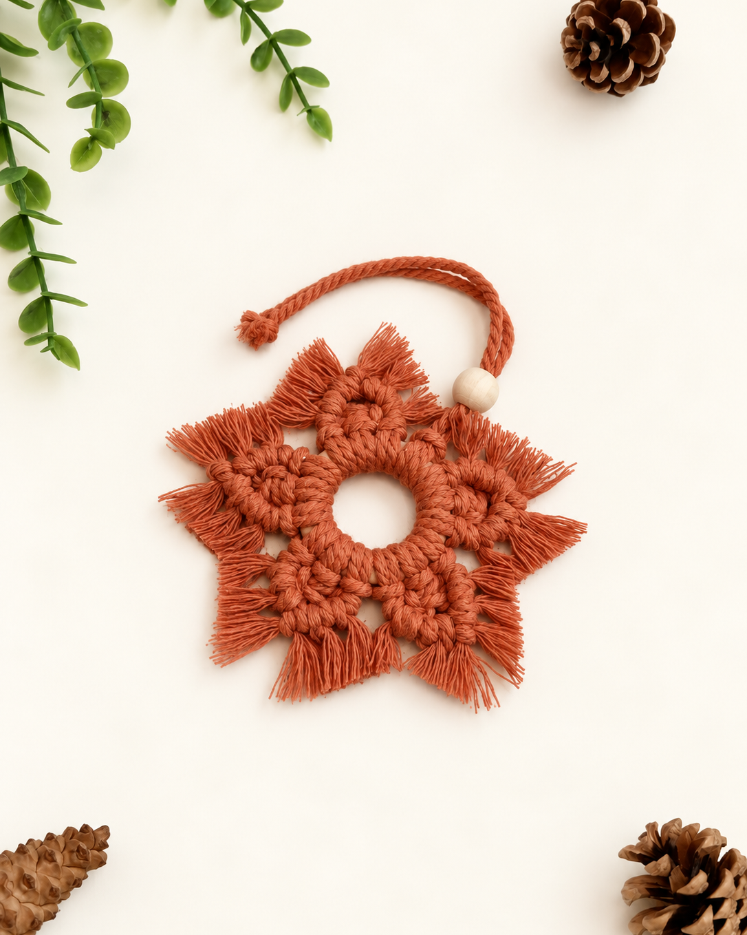 Handmade terracotta macrame snowflake Christmas ornament with wooden bead