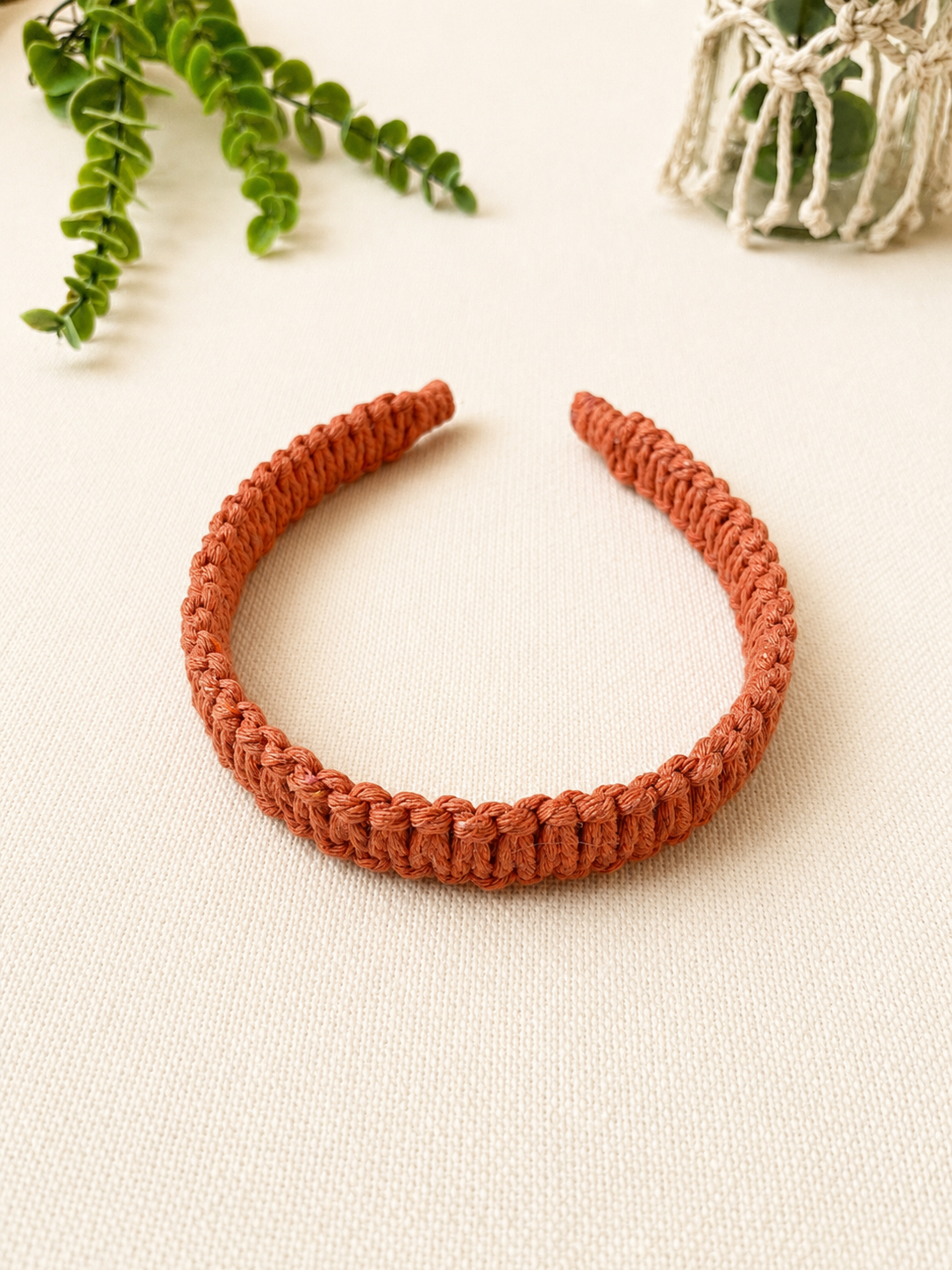 Handmade terracotta macrame square knot headband with a minimalist boho style.