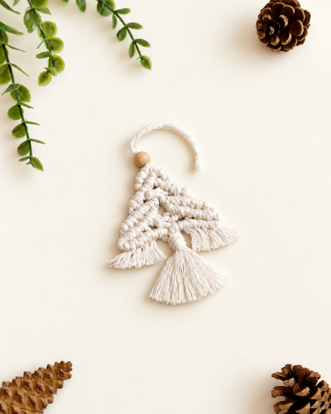 White macrame Christmas tree decoration handmade with cotton cord and wooden bead