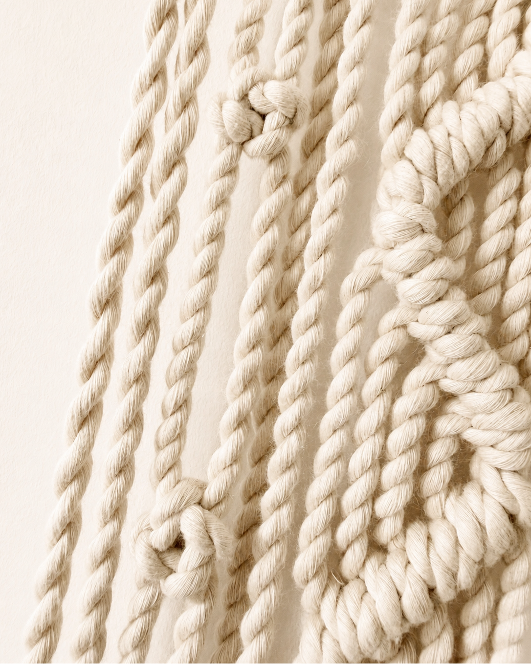 Detailed view of natural cotton cords and knots on Zigzag macrame star wall hanging